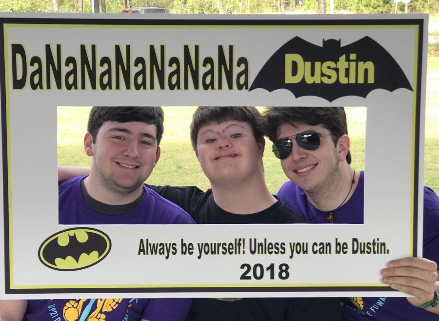 Senior Taylor Bourgeois stands with his cousins Dustin Gary (middle) and Cameron Gary (right) at the Up 21 Down Syndrome Awareness Walk on Saturday, March 24.